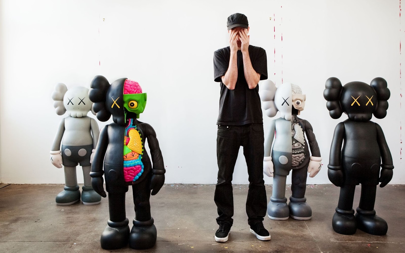 The artist KAWS with a group of KAWS statues from his COMPANION series.