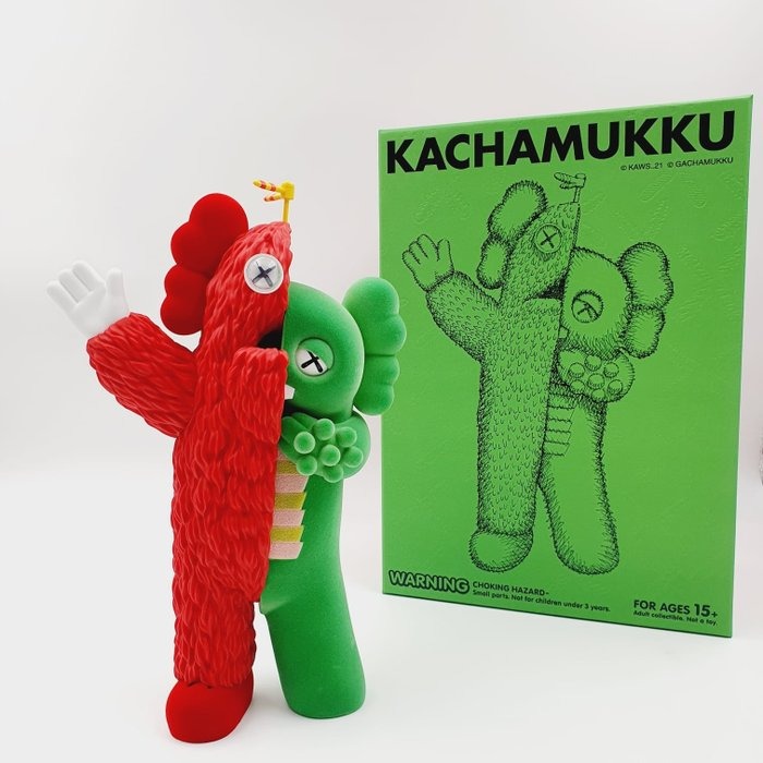 A Kachamukku Red & Green KAWS doll combines two Japanese children’s television characters, Gachapin and Mukku into an edition of KAWS collectibles.